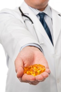 Fat burning diet - Doctor holding fish oil caps